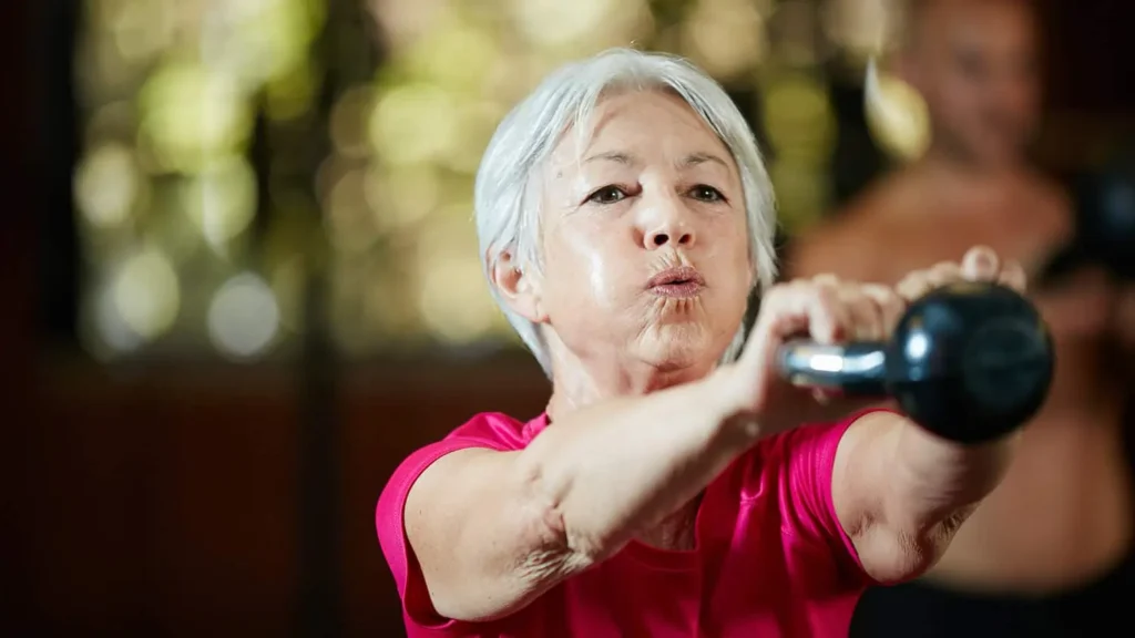 Toning Arms Without the Bulk: Is It Achievable? 1 Woman doing resistance band exercises for toned arms Doancaster